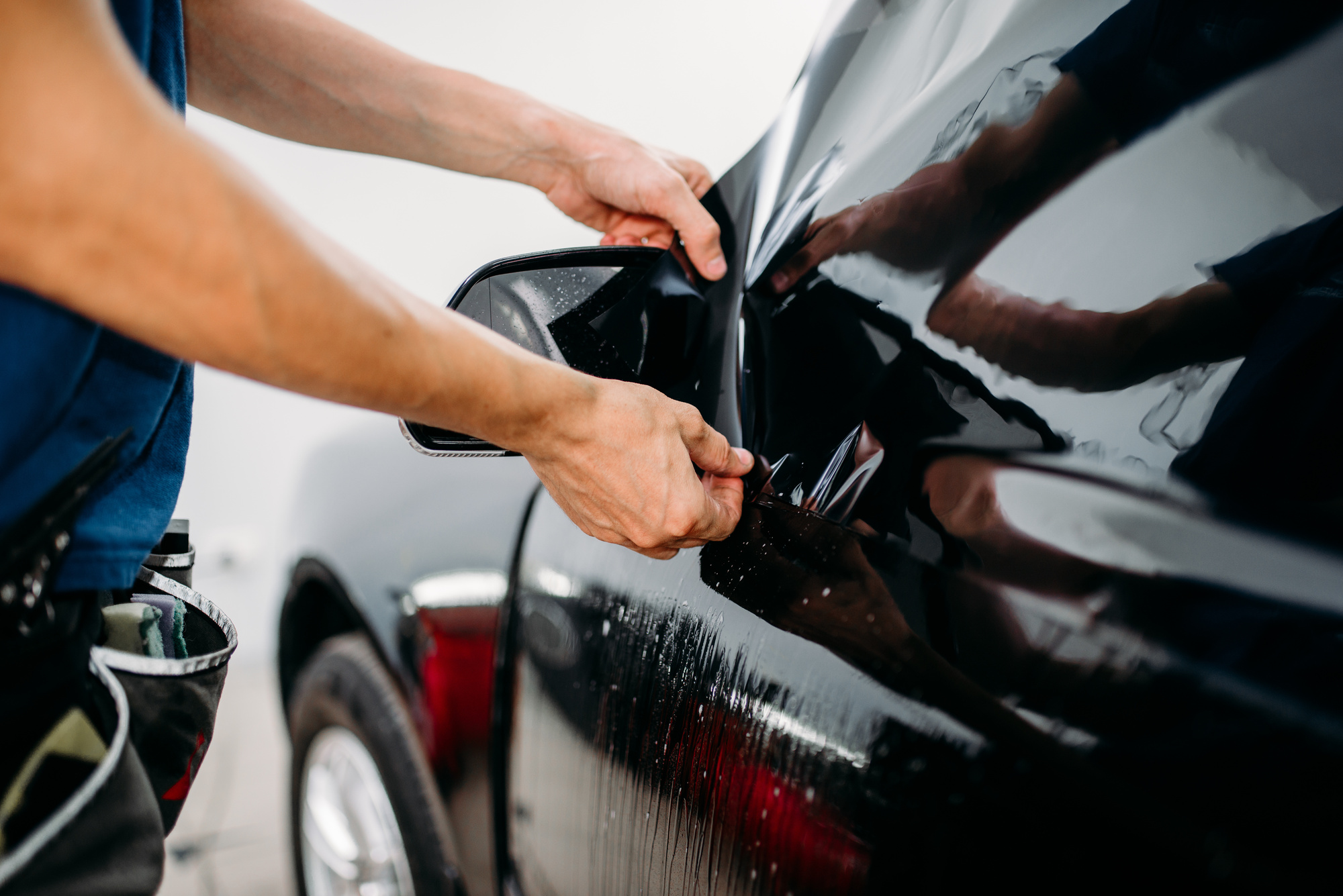 person installing window tint