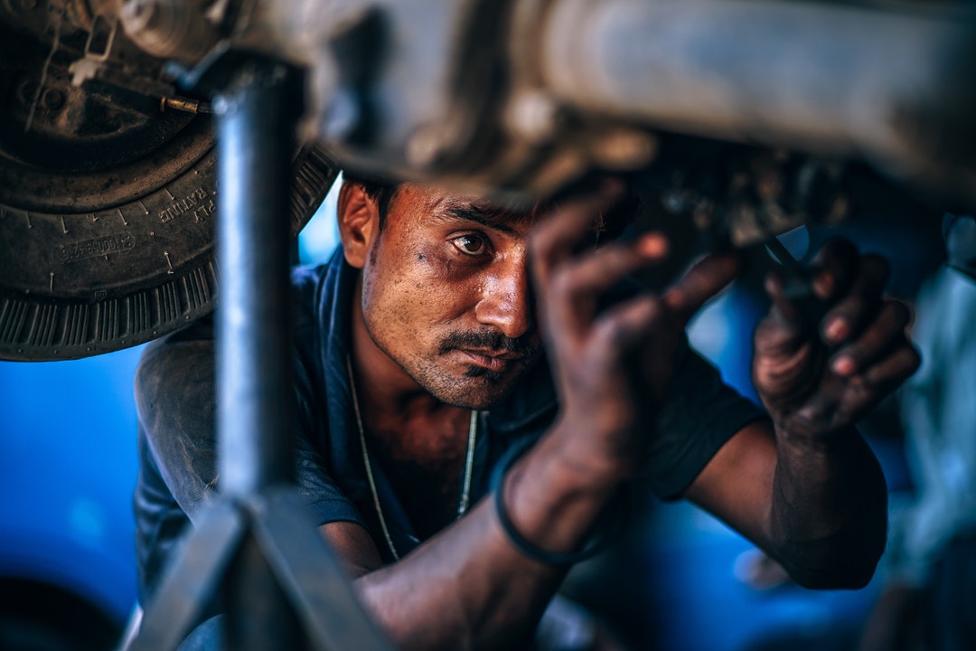 man performing car maintenance