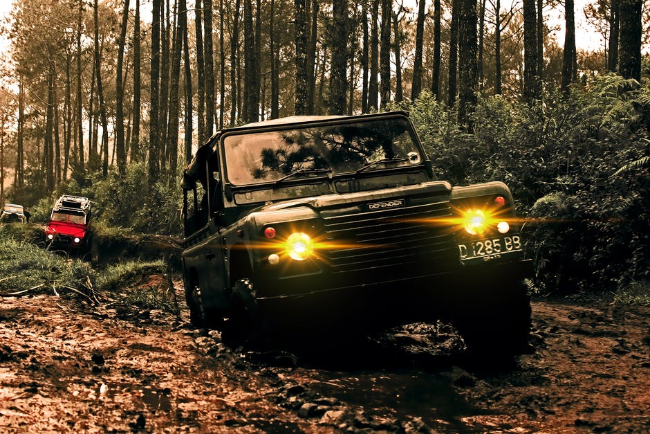 off road vehicle with wheels in mud