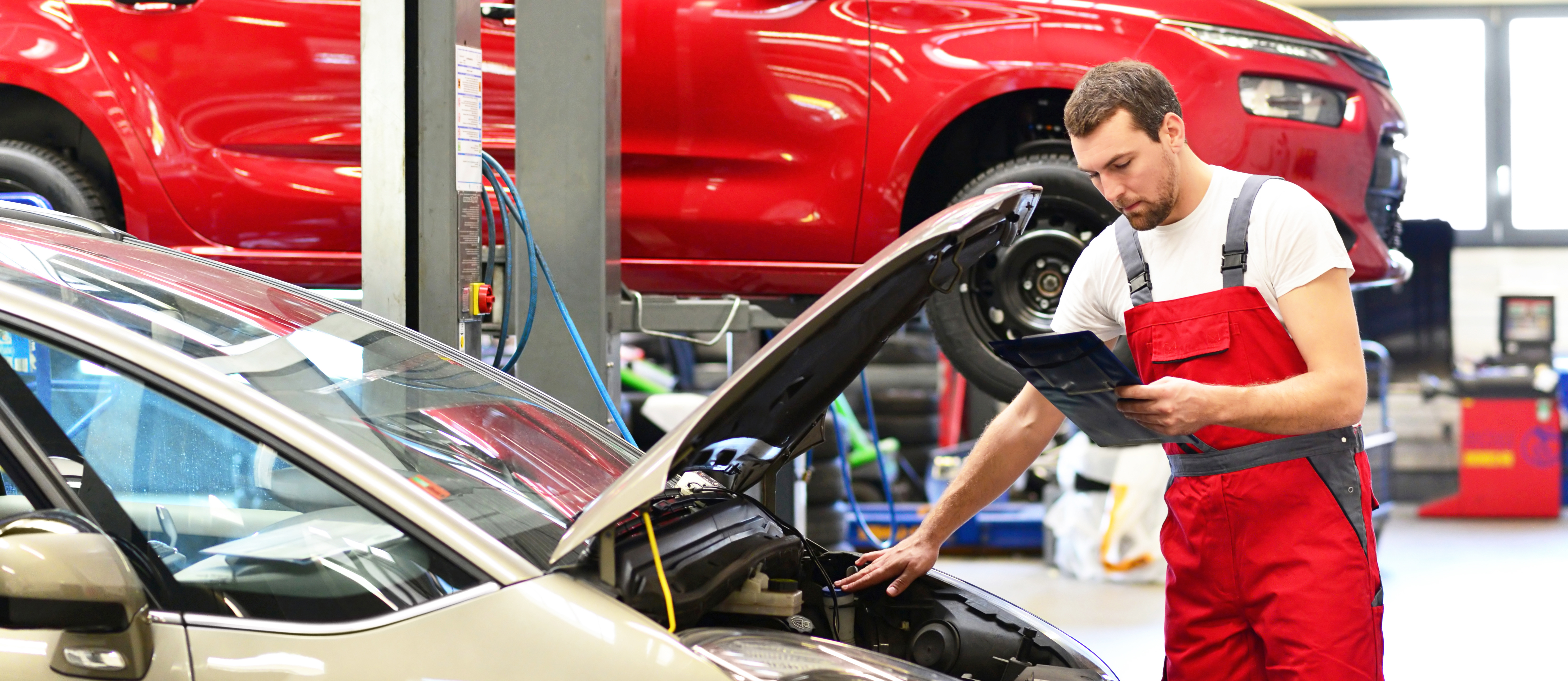 man servicing car