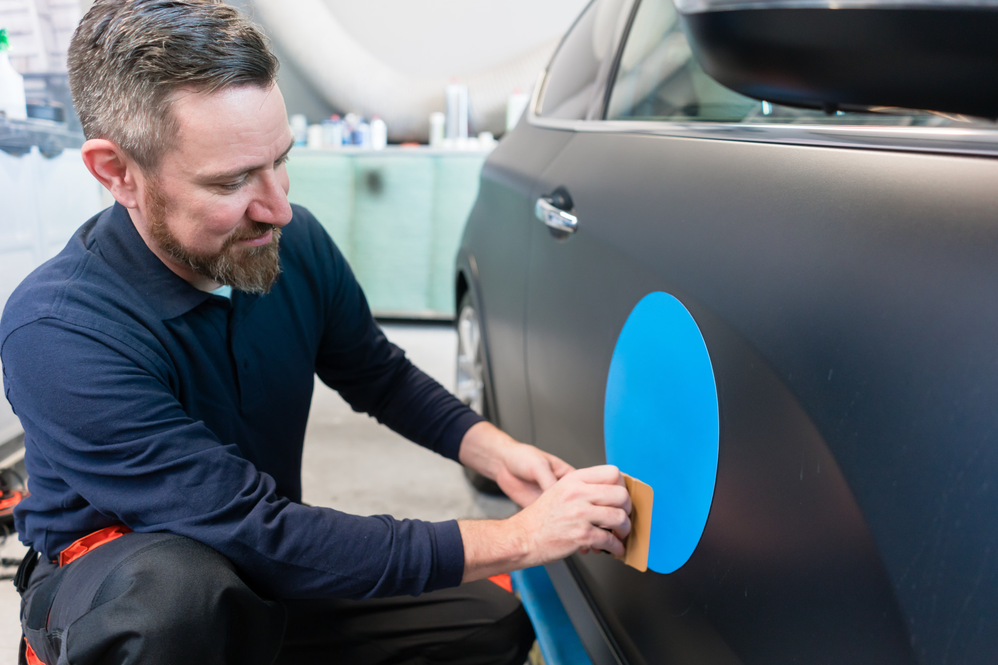 man installing car decal