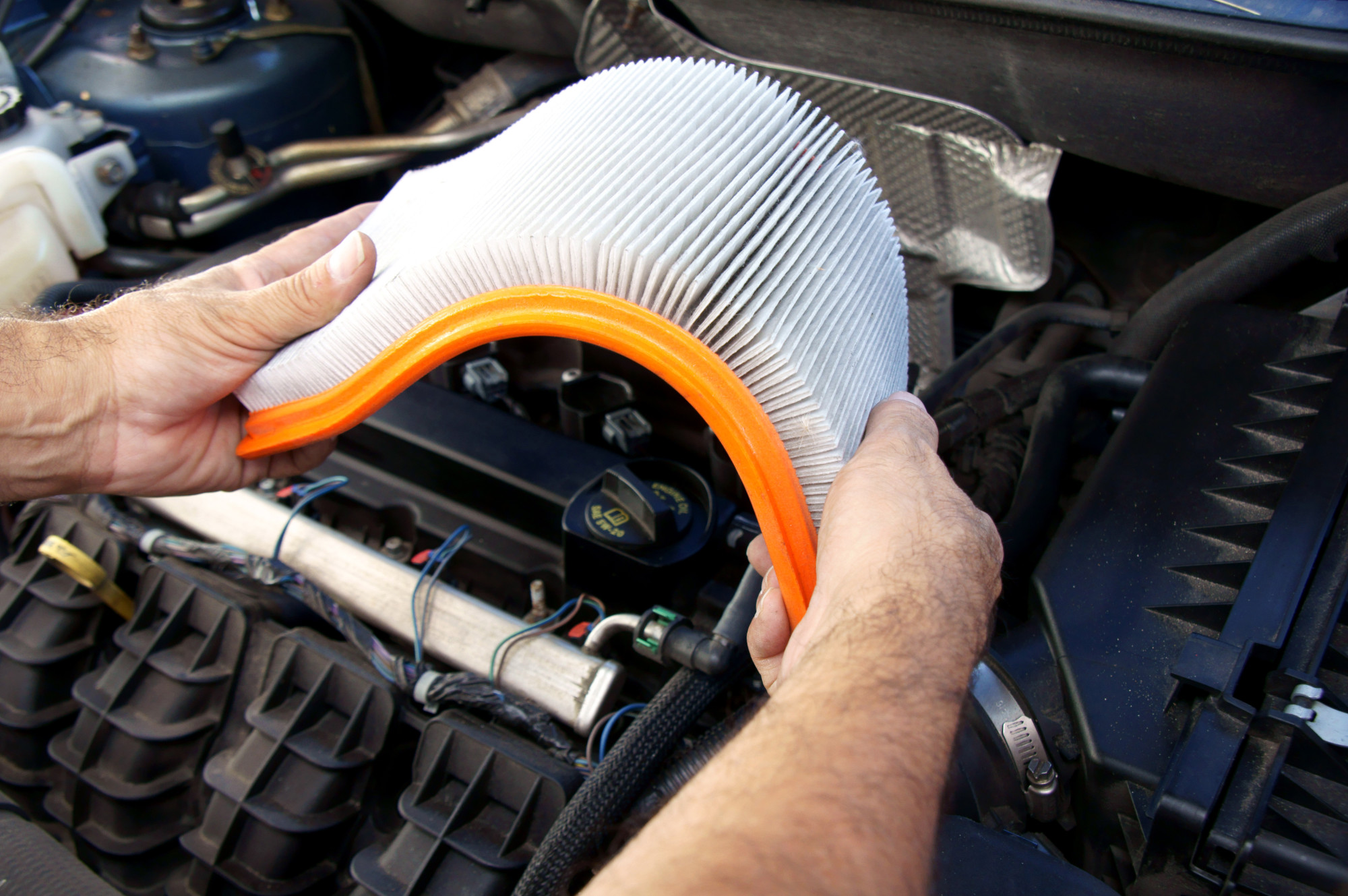 person holding car air filter