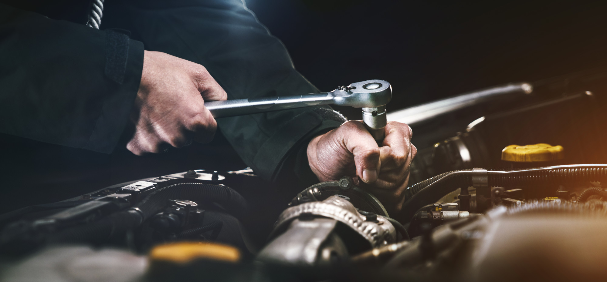 man repairing car