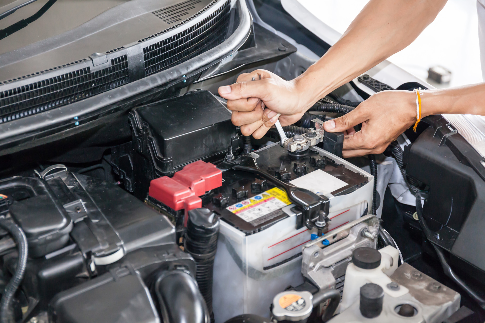 person working on car battery