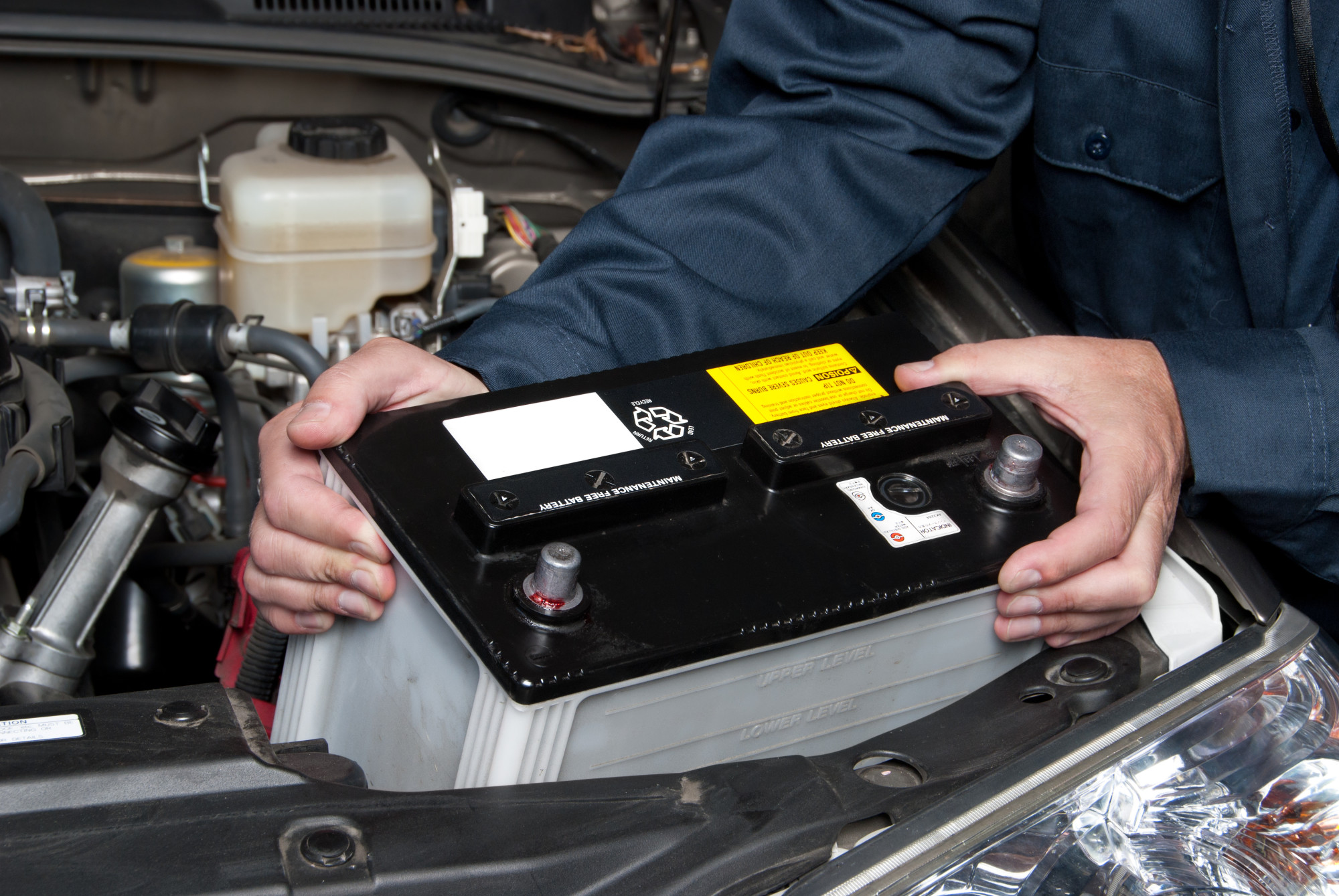 person replacing car battery