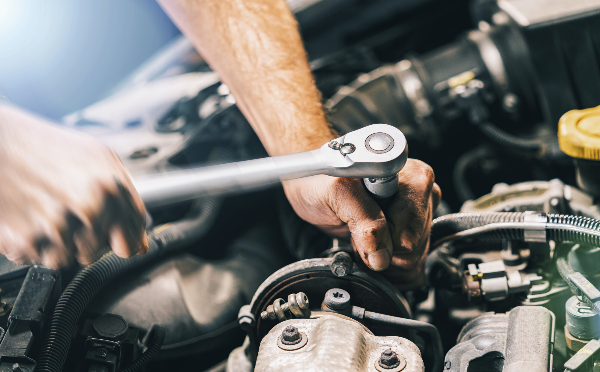 auto repair technician working on car