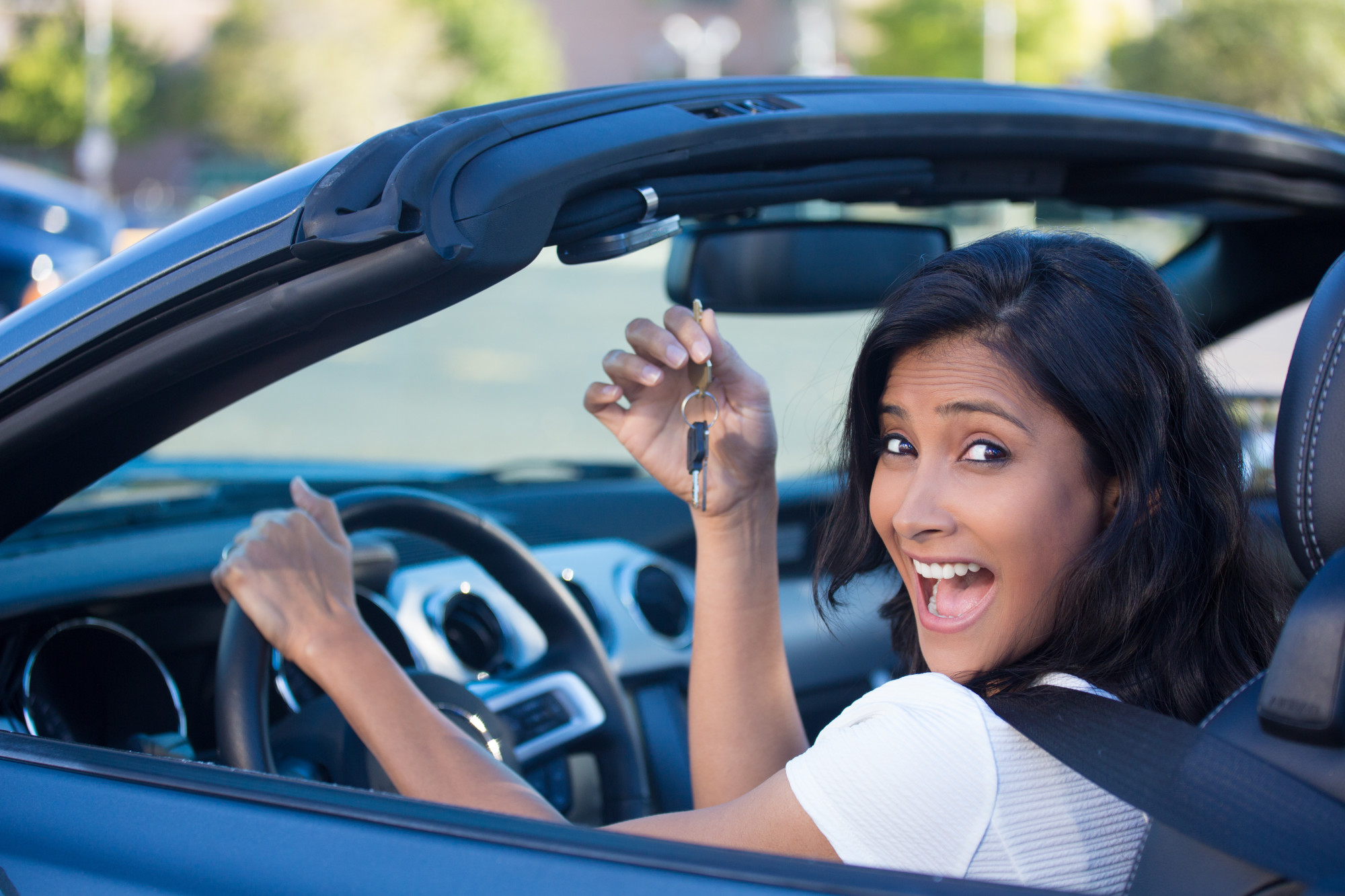 Woman Holding the Key of a New Car